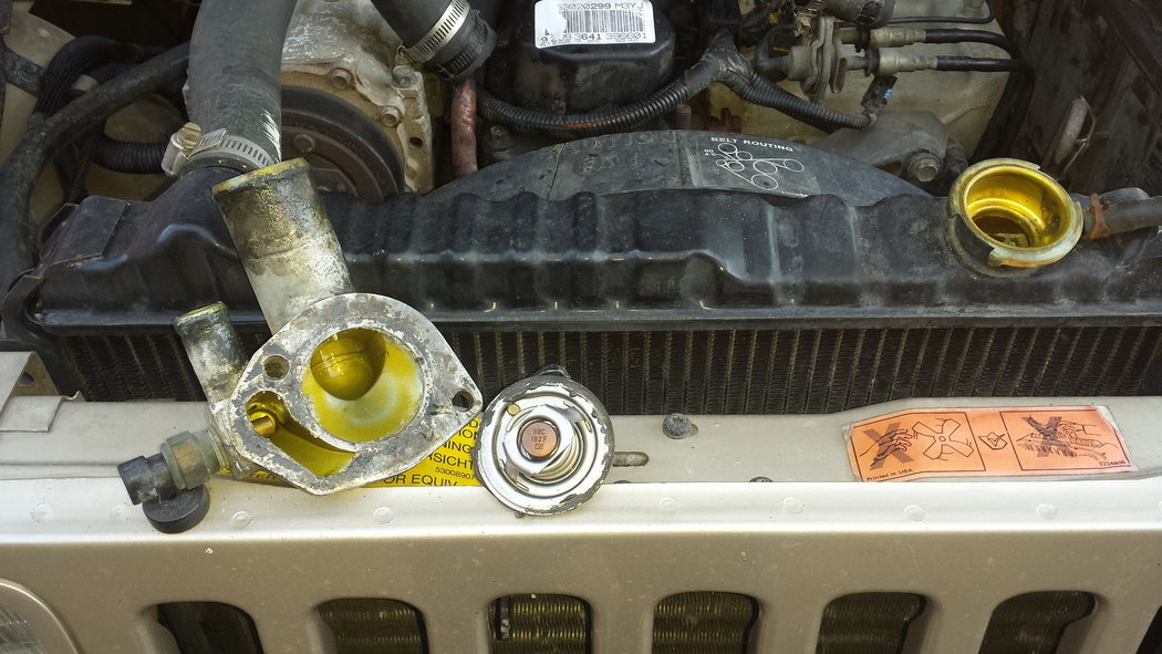 The thermostat housing and the old thermostat.